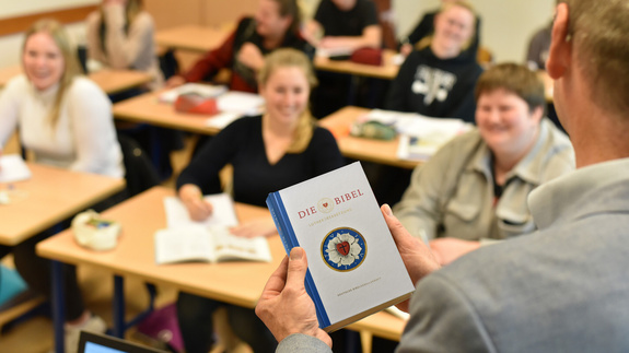 Man sieht Jugendliche in einem Klassenzimmer im Religionsunterricht