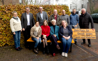 Am Internationalen Tag zur Beseitigung von Gewalt gegen Frauen wurde vor dem Ev.-luth. Oberkirchenrat in Oldenburg eine leuchtend orangefarbene Bank aufgestellt. Hier Mitglieder des Kollegiums und Mitarbeitende der Verwaltung bei der Einweihung der Bank.