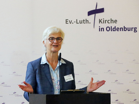 Oberkirchenrätin Gudrun Mawick steht am Rednerpult und spricht.