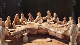 Detailreicher Holzschnitz von Jesus und seinen 12 Aposteln an der Tafel beim Letzten Abendmahl.