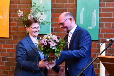 Der Vorsitzender der Kreissynode Pfarrer Helge Treiber (rechts) gratuliert Kreispfarrerin Birte Wielage.