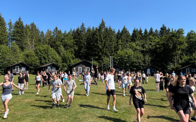 Viele Jugendliche laufen über eine große Wiese